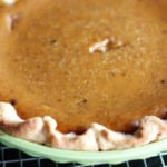 crisco pie crust with pumpkin pie filling in a green ceramic pie plate