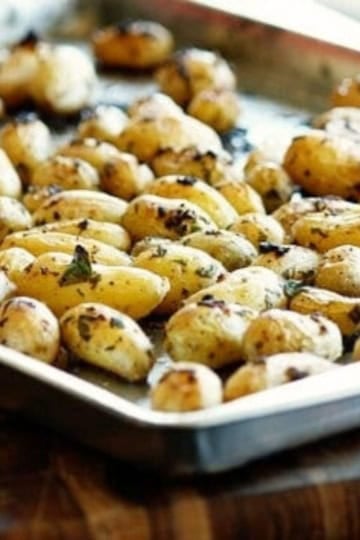 a sheet pan with roasted fingerling potatoes with garlic and parsley