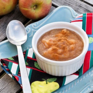 a white ceramic ramekin filled with homemade apple sauce sprinkled with cinnamon