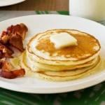 a stack of homemade bisquick ultimate pancakes with butter and maple syrup