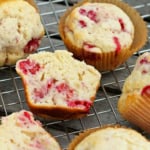 mixed berry muffins in brown muffin tin liners on a cooling rack
