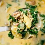 zuppa toscana soup in a ladle over a pot