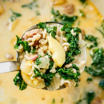 zuppa toscana soup in a ladle over a pot