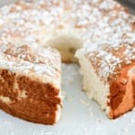 angel food cake on a ceramic cake stand dusted with confectioners sugar