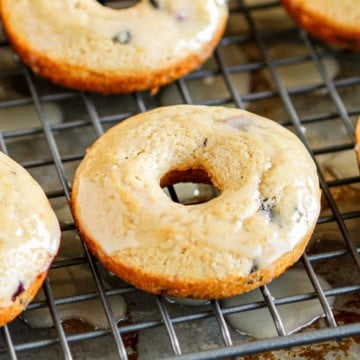 glazed blueberry baked donuts on a wire cooling rack