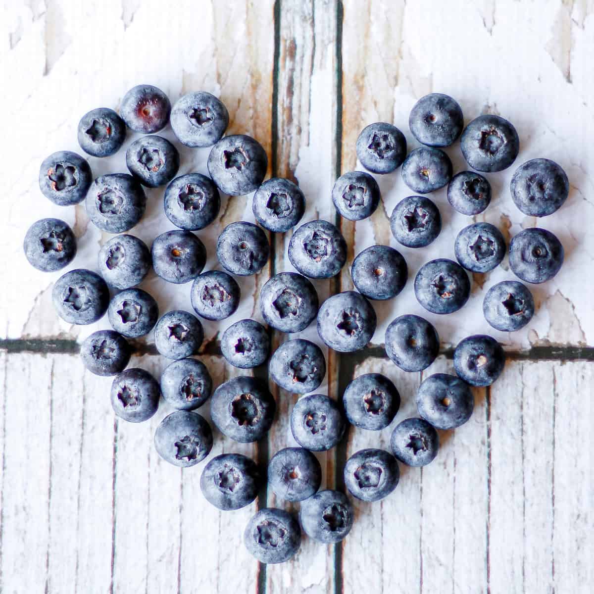 fresh blueberries arranged in a heart shape