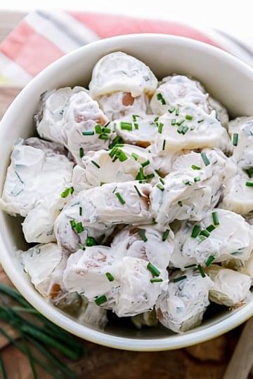 red skin potato salad with chives and a sliced lemon