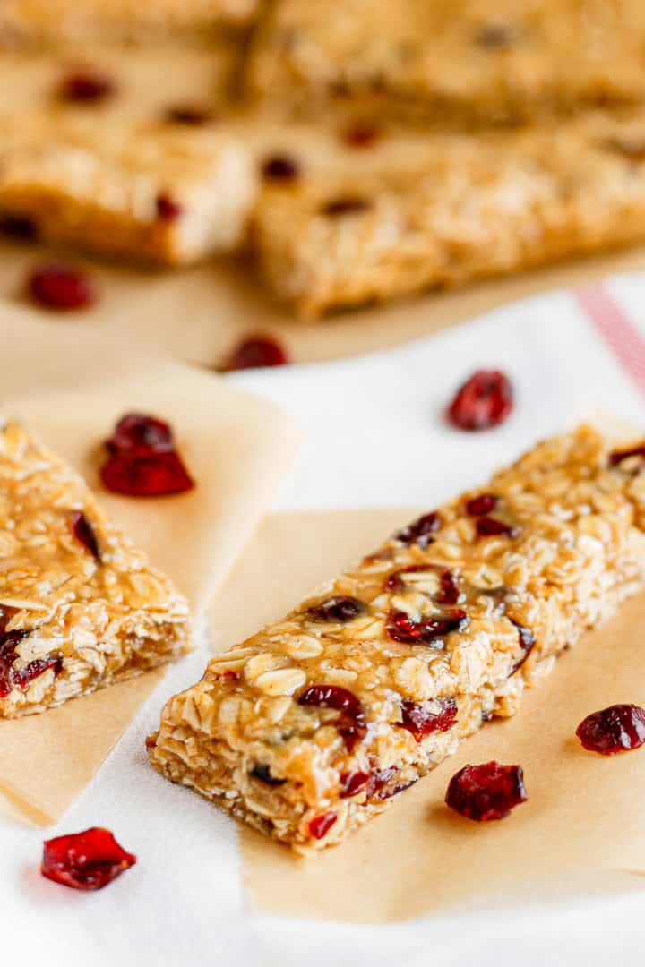 no bake peanut butter oatmeal bars with dried cranberries on parchment paper