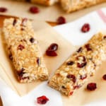 peanut butter oatmeal bars with dried cranberries on parchment paper
