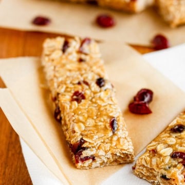peanut butter oatmeal bars with dried cranberries on parchment paper