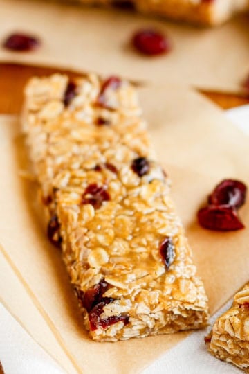 peanut butter oatmeal bars with dried cranberries on parchment paper