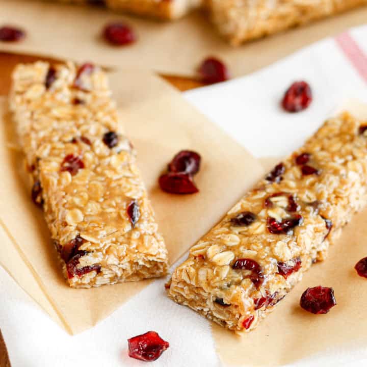 peanut butter oatmeal bars with dried cranberries on parchment paper