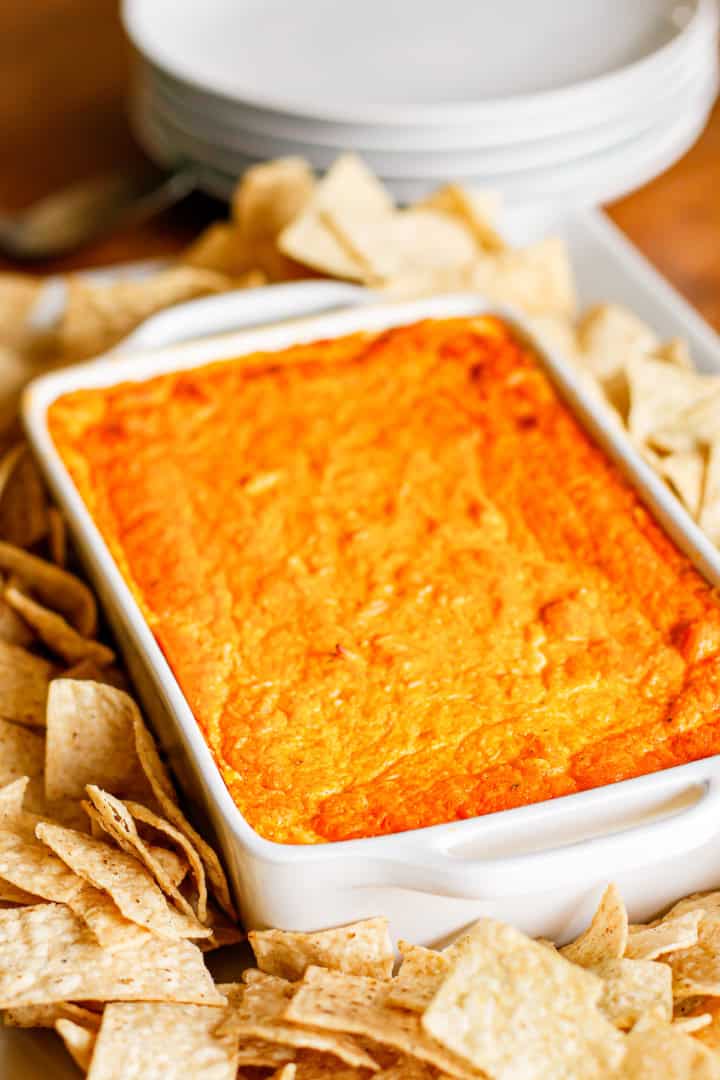 buffalo chicken dip with canned chicken in a white creamic baking dish surrounded by tortilla chips