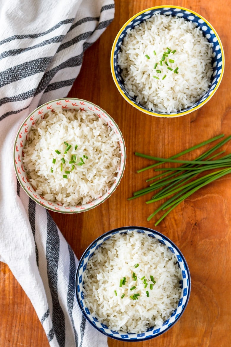 coconut rice recipe served in 3 bowls topped with chives