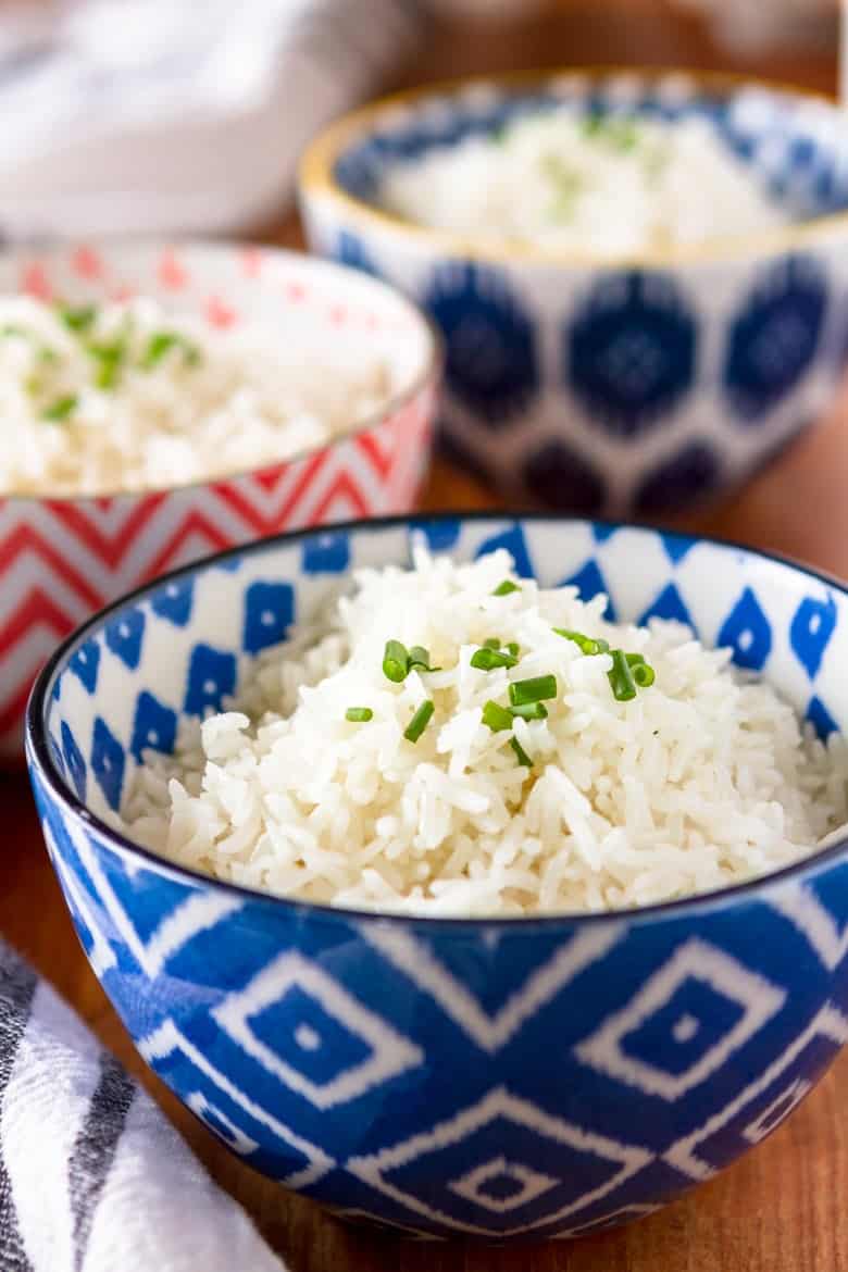 cooking rice in coconut milk served in a blue and white bowl