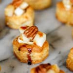 brie puff pastry bites with pear and pecans drizzled with balsamic reduction