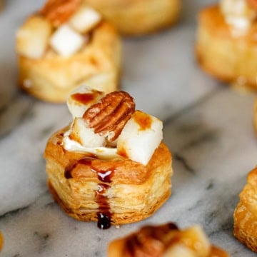 brie puff pastry bites with pear and pecans drizzled with balsamic reduction