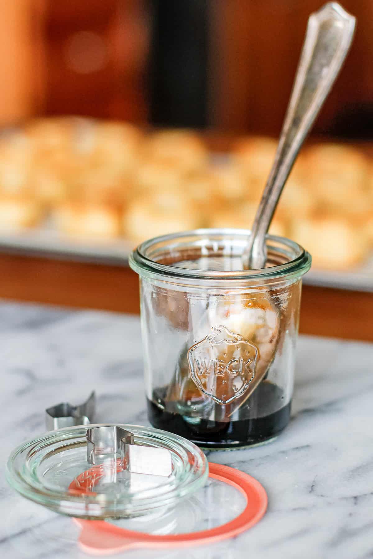balsamic vinegar reduction in a small weck jar with a silver plated spoon