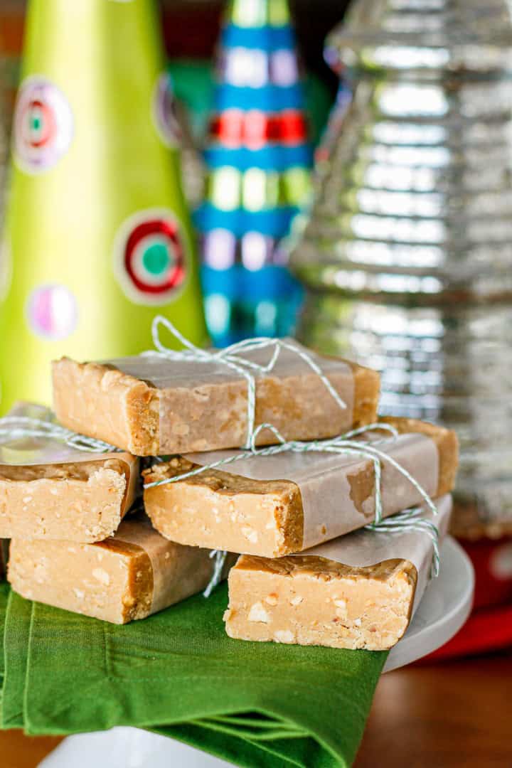 blocks of peanut butter fudge wrapped in waxed paper and tied with green and white string