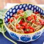 capellini pomodoro with angel hair pasta in a blue and white bowl with a yellow rim