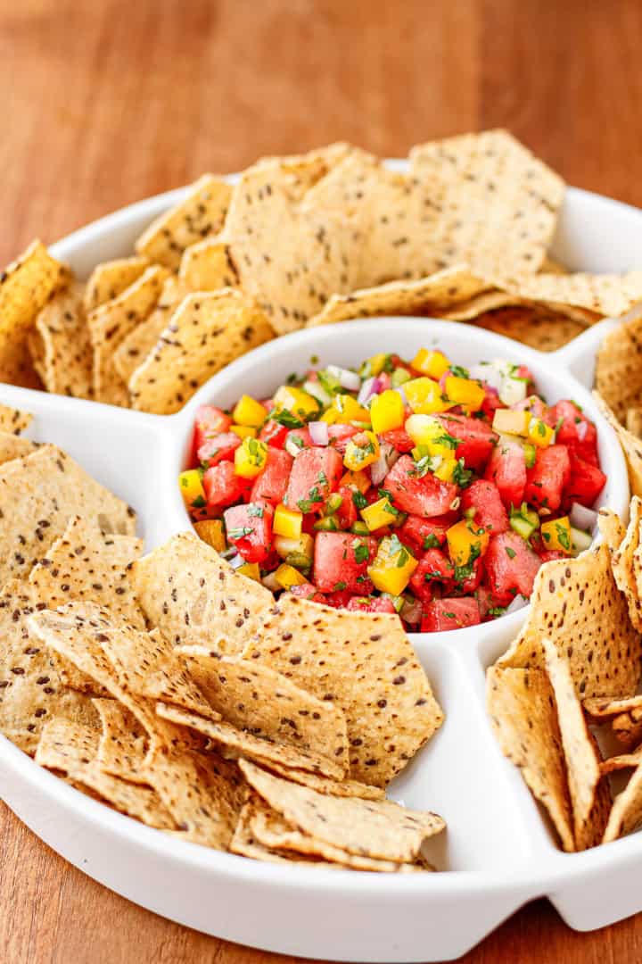 watermelon salsa with tortilla chips in a ceramic chips and dip serving tray