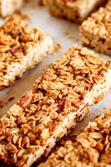 crunchy granola bars with pecans on parchment paper