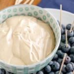 cream cheese dip for fruit in a patterned bowl with fresh blueberries