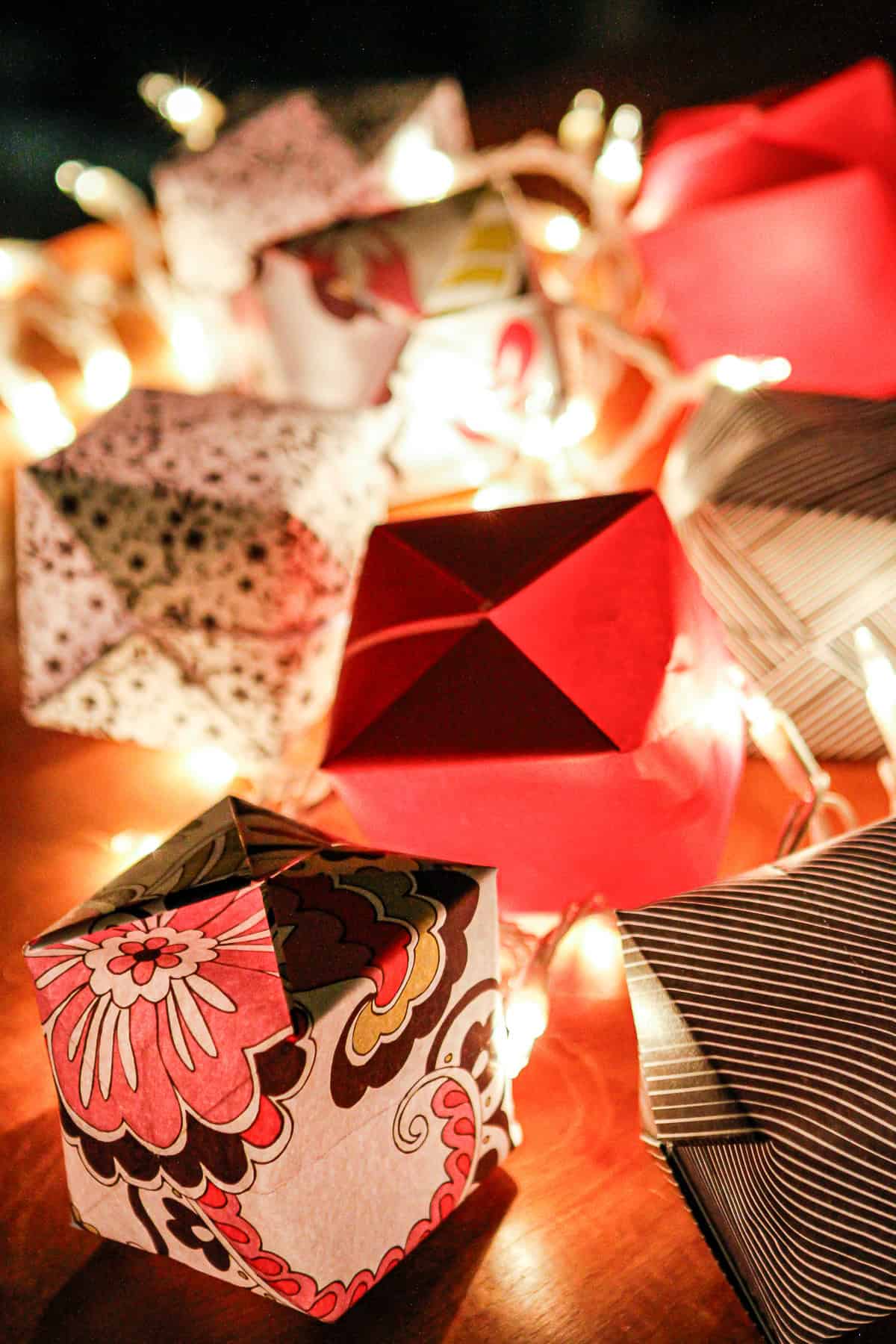 paper lantern string lights made with colorful scapbook paper lit up at night