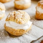 easy cream puff on parchment paper dusted with powdered sugar
