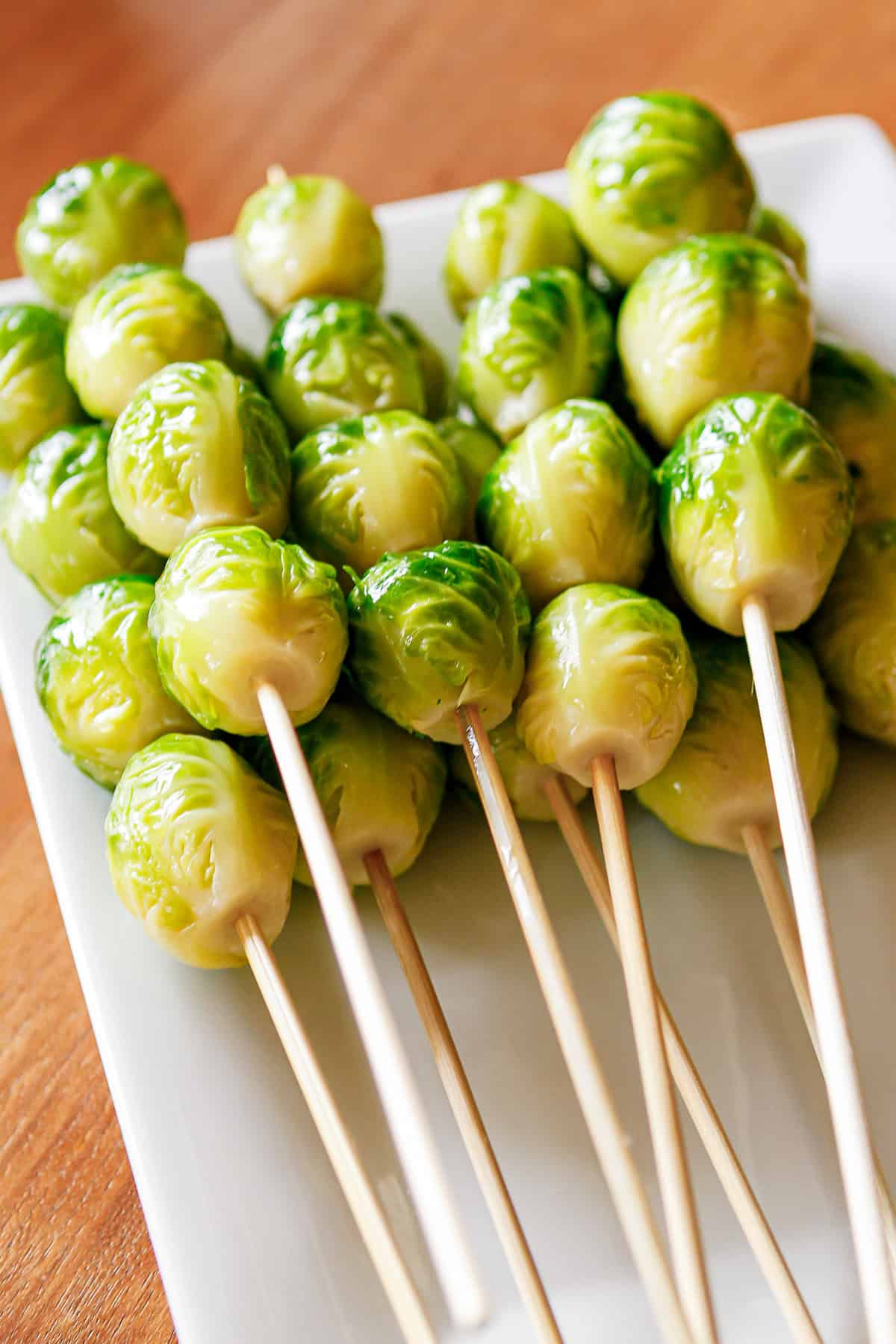 blanched brussel sprouts prepped for the grill on bamboo skewers