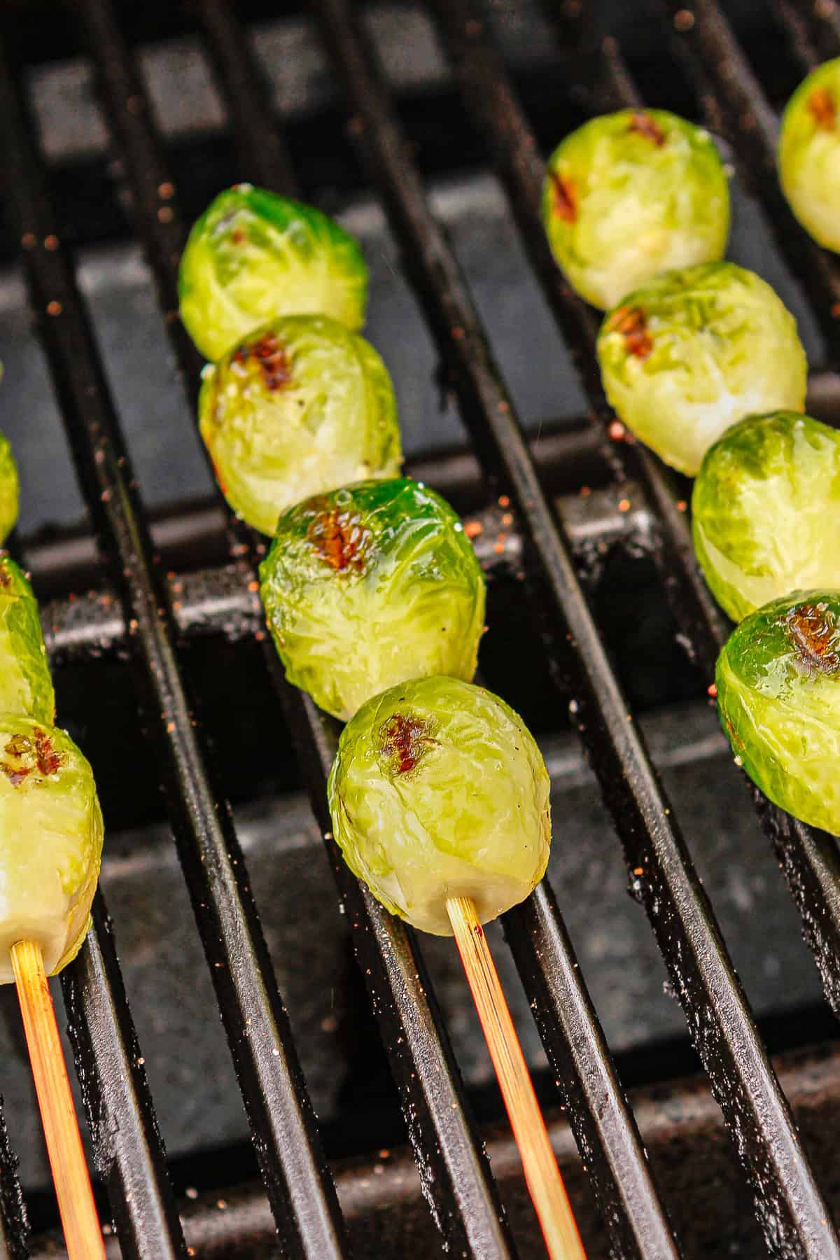 brussel sprouts on the grill getting charred on all sides