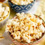 movie popcorn at home drizzled with clarified butter in ceramic bowls