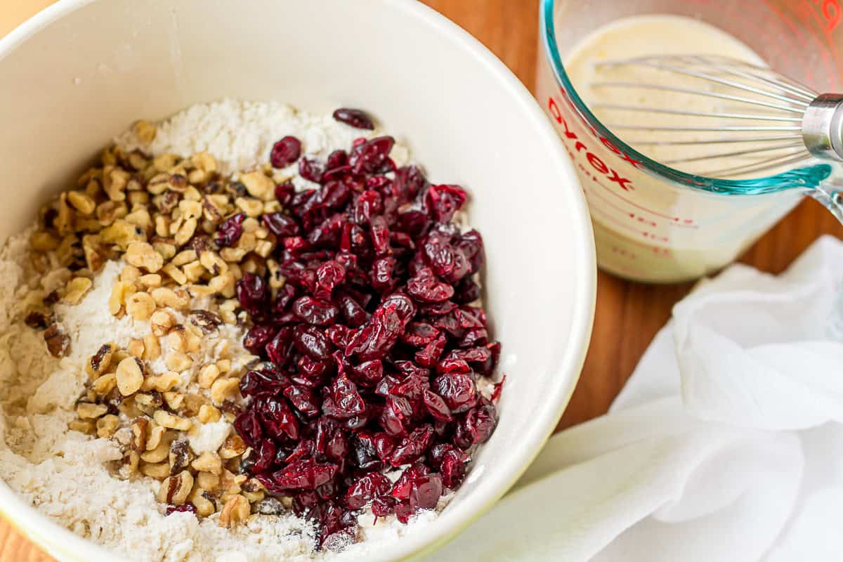 cranberry scone recipe ingredients in a ceramic mixing bowl