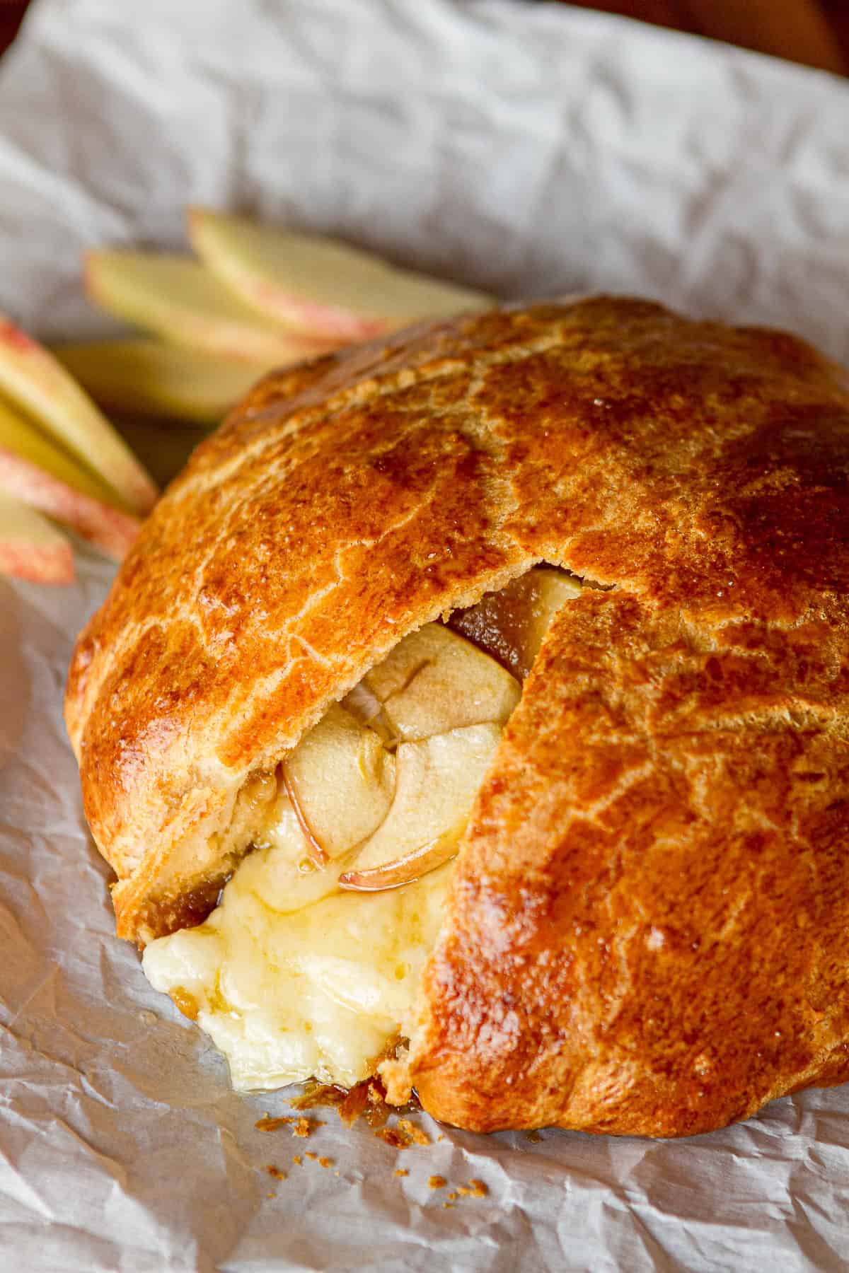 brie cheese baked in crescent roll dough with sliced apples