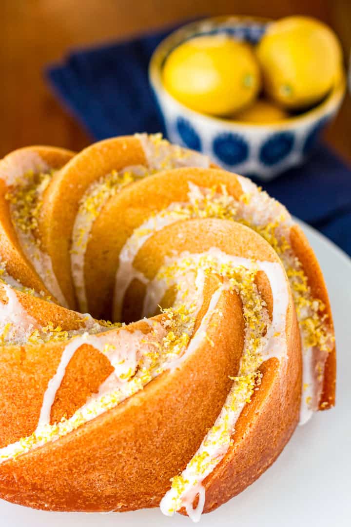 lemon bundt cake drizzled with lemon glaze and sprinkled with lemon zest