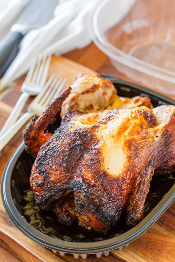 fully cooked rotisserie chicken in a plastic container