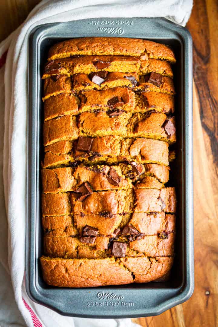 pumpkin chocolate chip bread sliced in a metal loaf pan