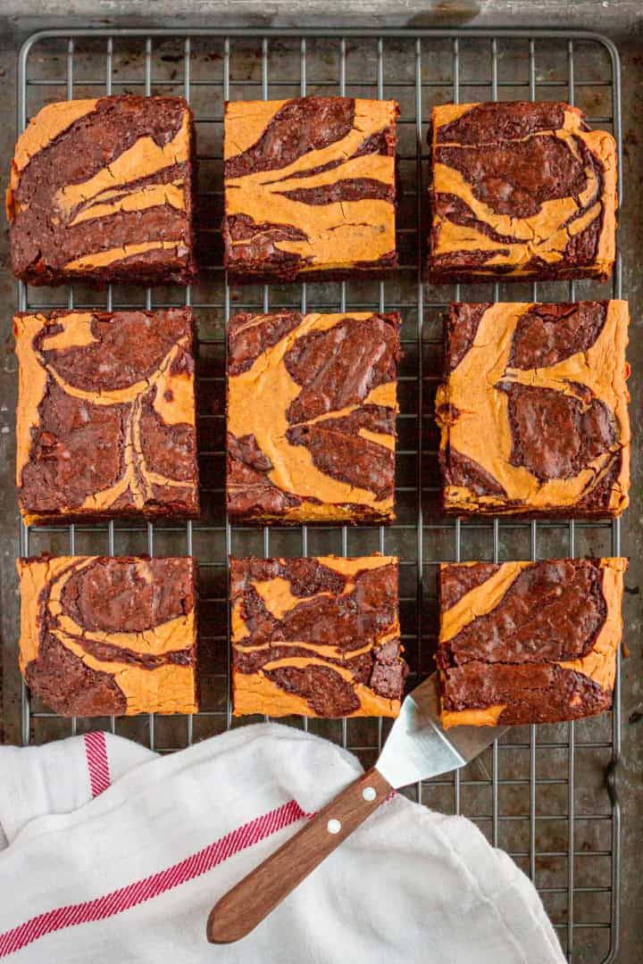 pumpkin brownies cut into squares on a wire cooling rack