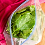 fresh spinach in a plastic ziploc bag