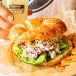 chicken salad recipe with grapes and roasted pecans on a croissant