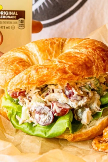 chicken salad recipe with grapes and roasted pecans on a croissant