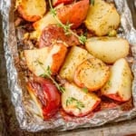 grilled potatoes in foil garnished with fresh thyme