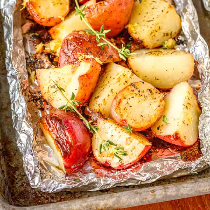 grilled potatoes in foil garnished with fresh thyme