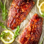 cedar plank salmon made with brown sugar grilled salmon seasoning with arugula and sliced lemons