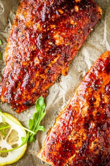 cedar plank salmon made with brown sugar grilled salmon seasoning with arugula and sliced lemons