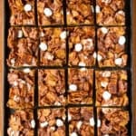 golden grahams s'mores bars on a textured baking sheet