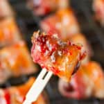 bacon wrapped dates with goat cheese and red pepper jelly glaze on a bamboo toothpick