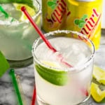 paloma drink recipe made with squirt and tequila plus limes and a pinch of salt in a highball glass with a red stir stick