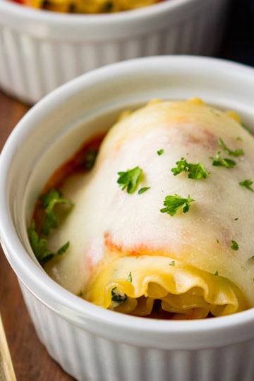 spinach lasagna roll ups in ceramic ramekins
