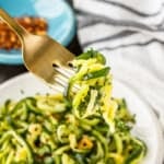 cooked frozen zucchini noodles twirled around a gold fork